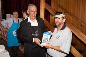 Tetra Pak Oceania managing director Noel Ayre takes a stint packing foods at the Foodbank warehouse.
